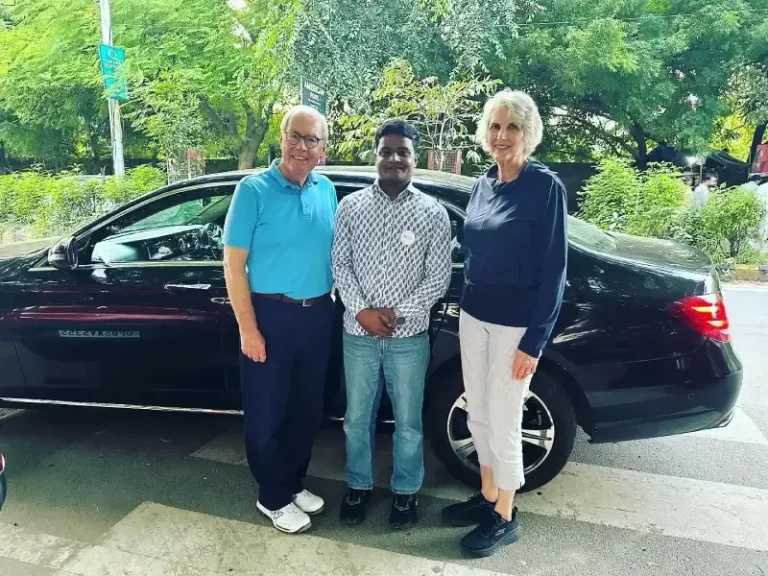Kevin O'Malley, former U.S. Ambassador, and his wife posing with their Indian tour guide during a Luxury Golden Triangle Tour in India.