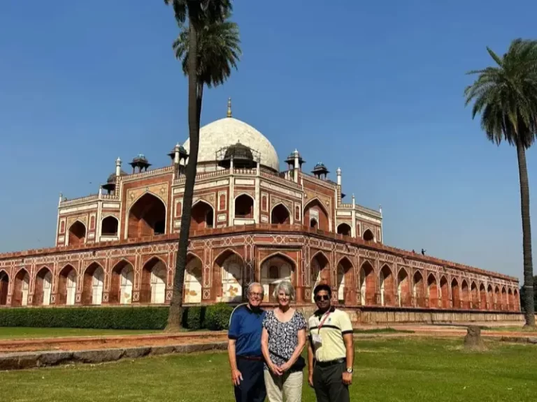 Kevin O'Malley, U.S. Ambassador, American lawyer, and diplomat with his wife, pose with their Indian tour guide in front of Humayun's Tomb in Delhi, India, during their Luxury Golden Triangle Tour.